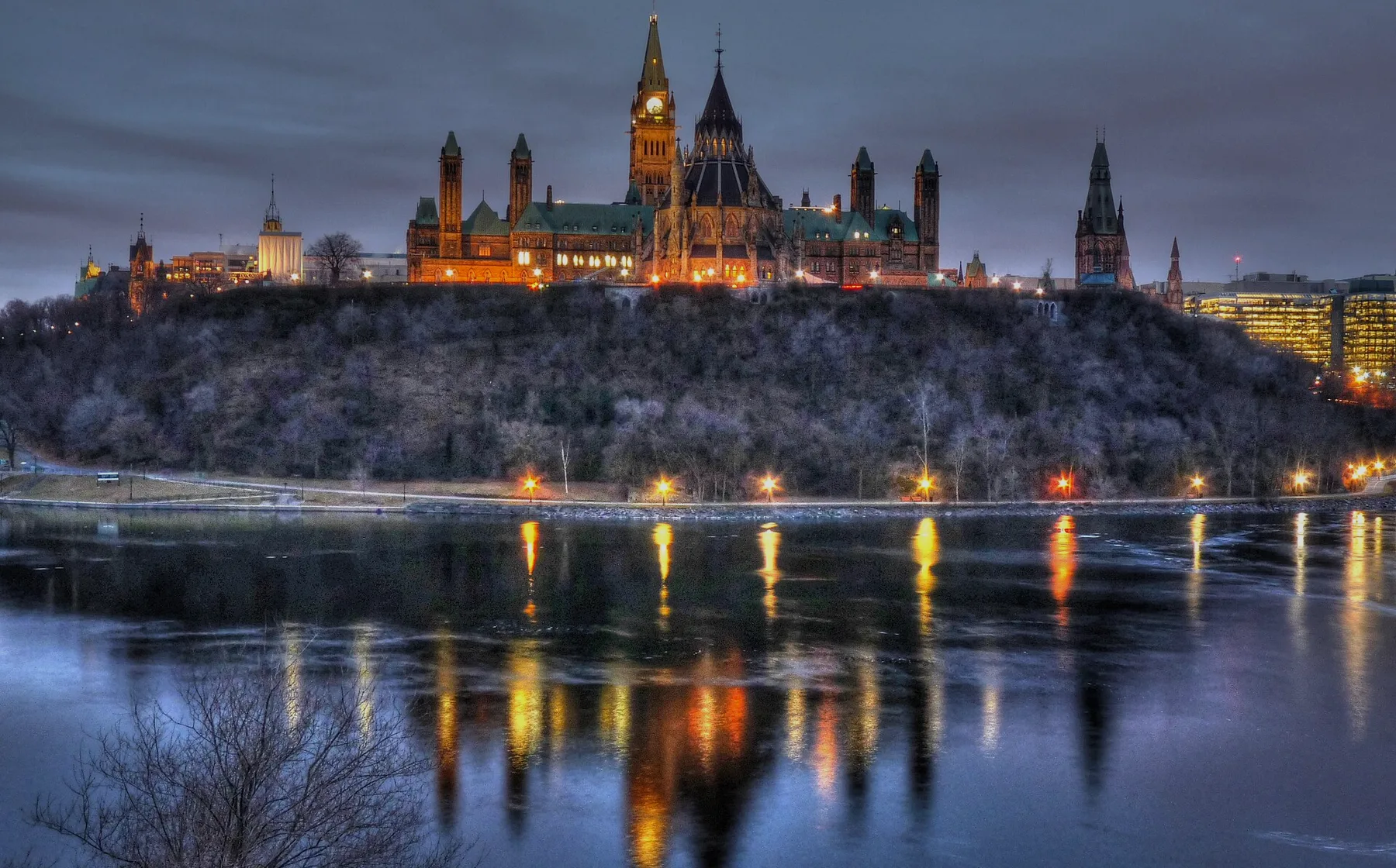 Ottawa skyline at blue hour with Parliament Hill above the river
